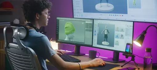 Game Design (B.A.) | Young 3D Designer erstellt Videospielcharakter oder Kleidung, arbeitet ferngesteuert auf Computer und großen digitalen Bildschirmen mit professioneller Software-Schnittstelle und Tools für 3D-Modellierung und Design.